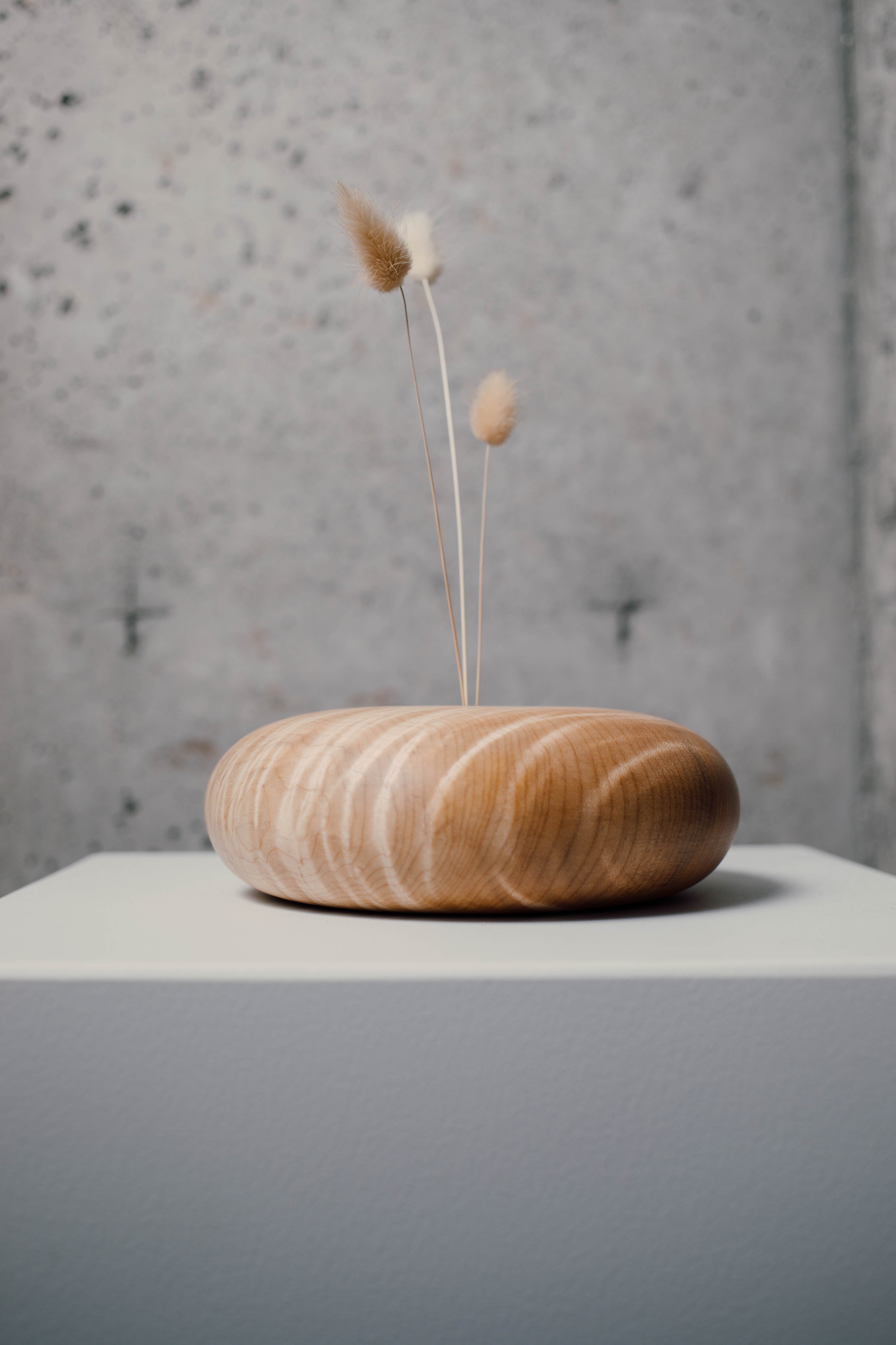 round pebble shaped budvase handmade from wood by modern wood designer Jackie Chapman